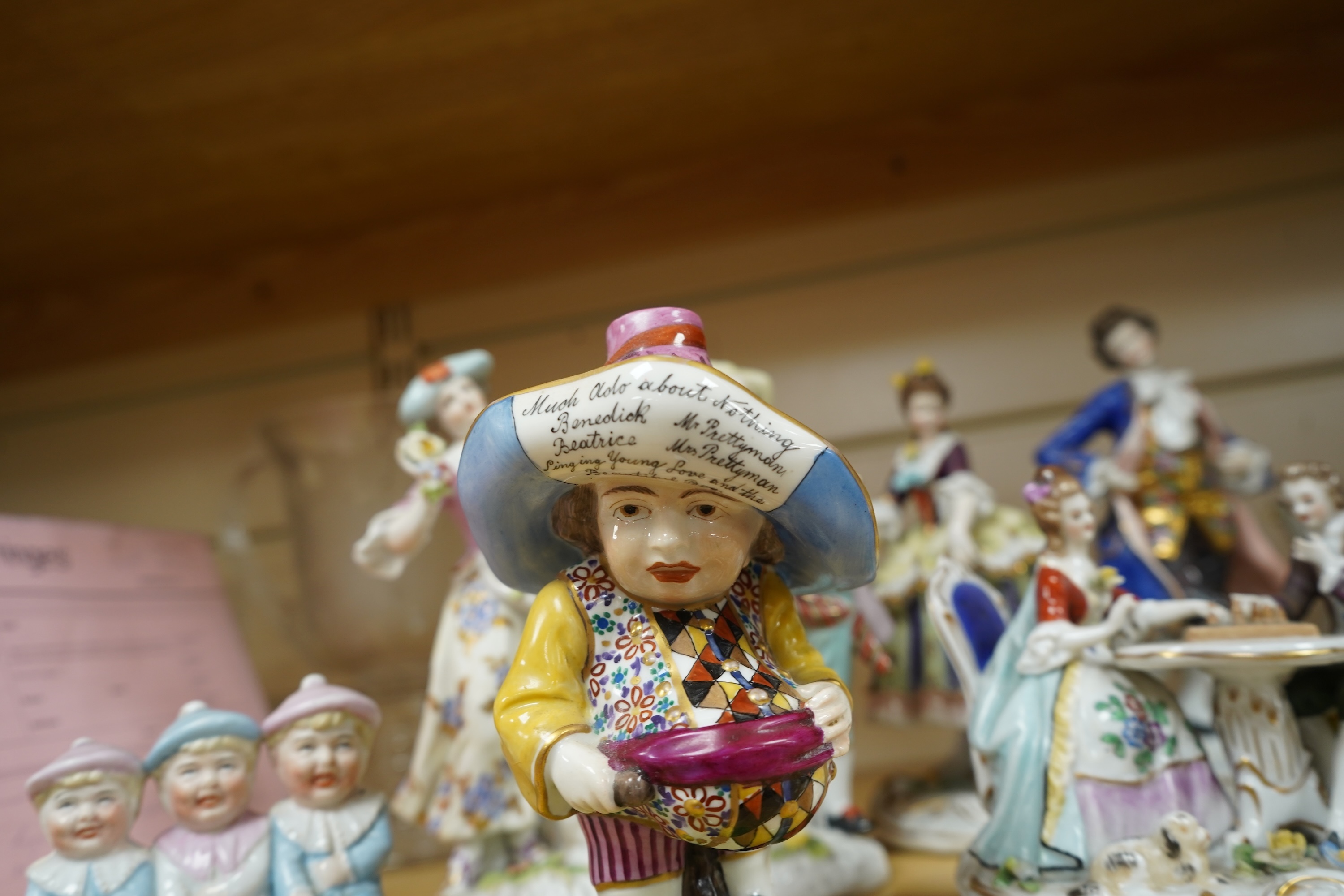 A French porcelain figure of a Mansion House dwarf, various German porcelain figures, an engraved glass and bowl. Glass 19cm